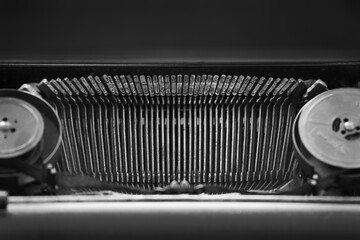 Close up of dirty individual typewriter hammers. Metal letters and elements of vintage and retro devices with copy space.
Detail of an old typewriter, mechanical detail, close up photo of hammers