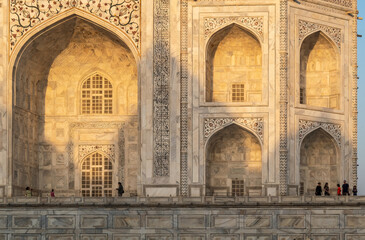 Dawn light hits the arches of the Taj Mahal