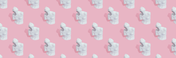 White woman statue on pink background