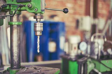 drilling machine against the background of the workshop.