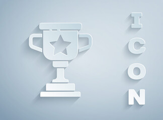 Paper cut Award cup icon isolated on grey background. Winner trophy symbol. Championship or competition trophy. Sports achievement sign. Paper art style. Vector.