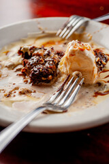 Fudge chocolate brownie Dessert with vanilla ice cream. Classic American or French bakeries or pastry shop favorites. Cookies, whipped cream, cakes, chocolate syrup butter, eggs and vanilla beans.