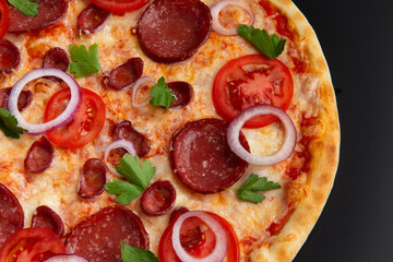 pizza with tomatoes, pepperoni and herbs