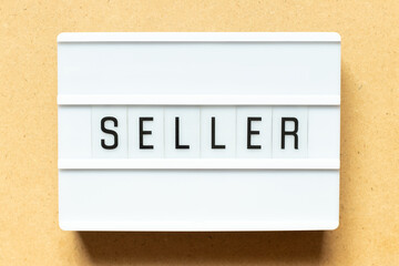 Lightbox with word seller on wood background