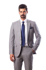 A young man wearing a black suit on a white background