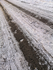 Fototapeta premium Car tracks on frozen ground as background.