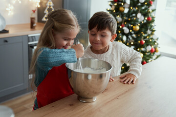 Brother and sister baking together