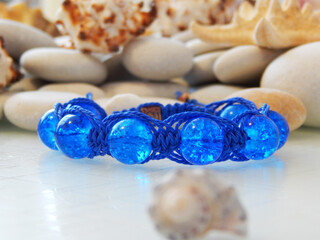 blue bracelet and white pebbles