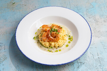 scrambled eggs with fried shrimps in a plate