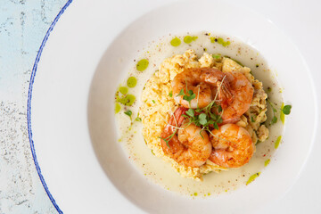 scrambled eggs with fried shrimps in a plate