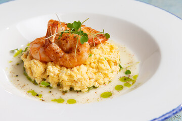 scrambled eggs with fried shrimps in a plate