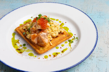 waffles with scrambled eggs decorated with red caviar
