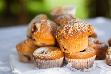 Outdoor studio photo of fresh muffins on a glass plate with bright vivid background. Shallow depth of field, selective focus.