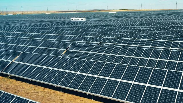 Solar power, solar panel, solar farm concept. Rows of solar batteries filmed on a high speed