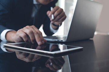 Multitasking businessman busy working on computer devices surfing the internet in modern office