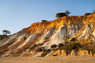 Orange dunes of Falesia Beach at sunset. Albufeira, Algarve, Portugal.