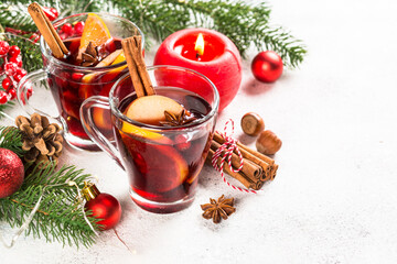 Mulled wine with christmas decorations on white.