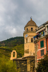 Nice close-up view of the famous octagonal bell tower with a yellow fa&ccedil;ade, a dome and a clock which belongs to the Church of Santa Margherita d'Antiochia in Vernazza in the Cinque Terre coastal area.