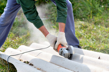 work with a smog grinder. trim the slate. working dust at the construction site. repair work on the site.  