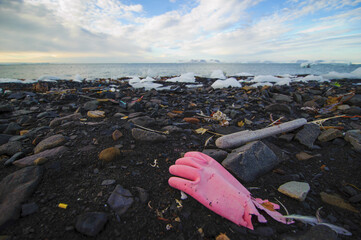 Discarded as garbage rubber (silicone) glove on the beach (ocean) Environmental pollution, garbage...