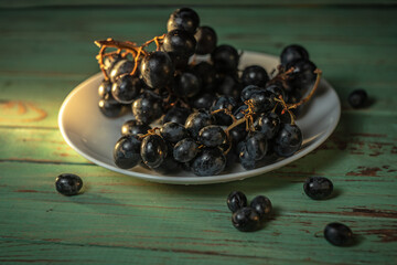 Fresh natural grapes on a plate in the morning sunlight