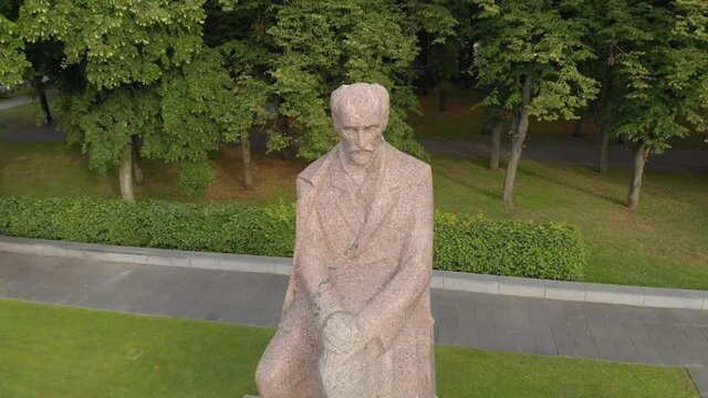 Rainis statue in Esplenade park, Riga, Latvia, aerial drone circling around, day
