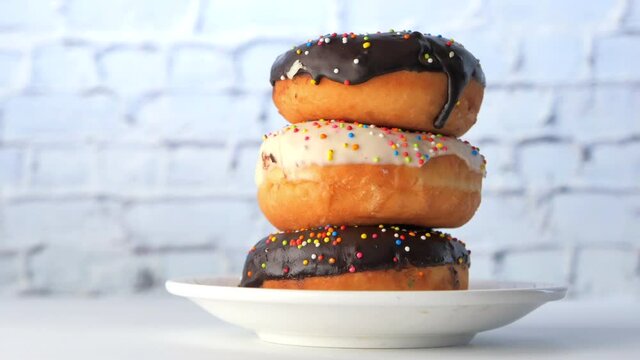 stack of chocolate donuts on plate with copy space 