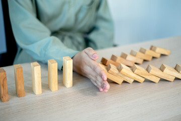 Businesswoman hand stop wooden blocks for protect other wooden block, Concept Risk of management and strategy plan