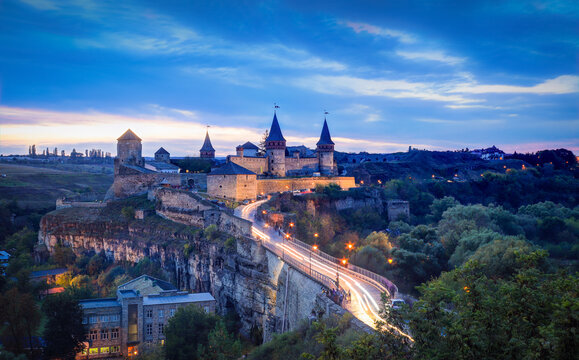 Panoramic  night view of ancient fortress castle in Kamianets-Podilskyi, Khmelnytskyi Region, Ukraine. Old ?astle photo on a postcard or cover. Long exposive