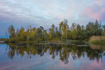 Fototapeta na wymiar Watercolored Sunset autumnal riverscape with symmetry reflection.