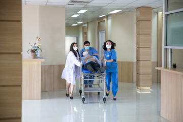 The doctor was rushing into the intensive care unit in the emergency bed, the patient was very...