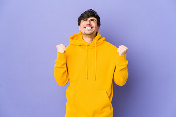 Young cool man celebrating a victory, passion and enthusiasm, happy expression.