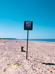 a sign indicating the boundaries of the beach for nudists