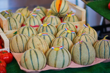 Large heap of fresh ripe organic melons on farmer market in Paris