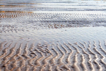 Wet sand after low tide on the beach