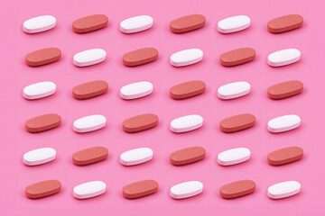 Oval shape Pharmaceutical medicine tablet on a pink background,Medicine creative concepts. Minimal style with colorful paper backdrop.Trendy colors,Trendy pattern