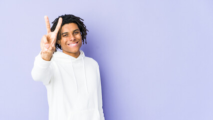Young african american rasta man showing victory sign and smiling broadly.