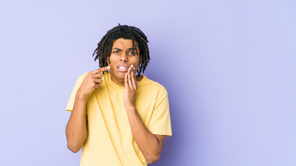 Young african american rasta man having a strong teeth pain, molar ache.