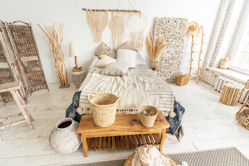 Large spacious room with a trendy loft design of sitting area. huge windows and stylish wicker...