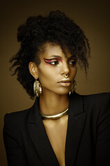 Beautiful afro girl wearing a blazer and gold jewelry