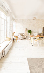 Large spacious room with a trendy loft design of sitting area. huge windows and stylish wicker light furniture inside. an abundance of ethnic decor