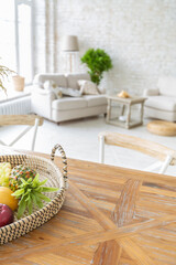 Large spacious room with a trendy loft design of sitting area. huge windows and stylish wicker light furniture inside. an abundance of ethnic decor