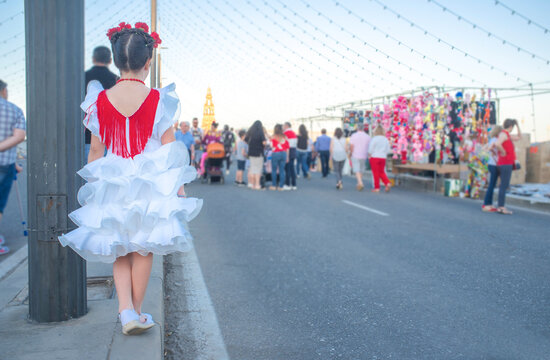Little girl traditional gipsy dressed getting close to Cordoba Fair Cover