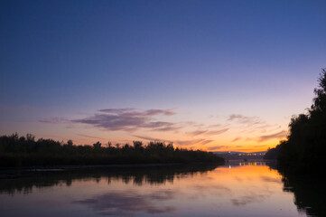 Obraz na płótnie Canvas River Guadalquivir bank at sunset