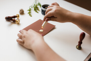 sealing wax is dropped on the brown envelope for printing