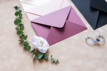 pink and blue mother-of-pearl envelopes on a background of velvet paper