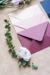 pink and blue mother-of-pearl envelopes on a background of velvet paper