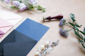 pink and blue mother-of-pearl envelopes on a background of velvet paper