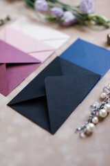 pink and blue mother-of-pearl envelopes on a background of velvet paper