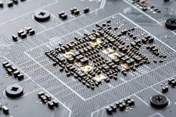 Electronic PCB printed circuit board in macro close-up with transistors circuitry and electric...